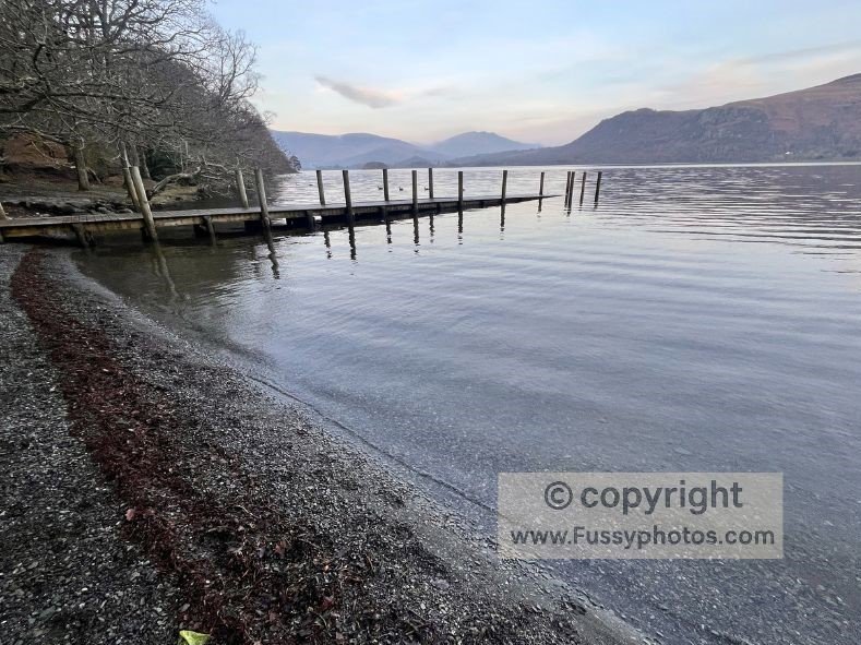 The Cumbrian Way heading north through the woods with lakeside views over Derwentwater