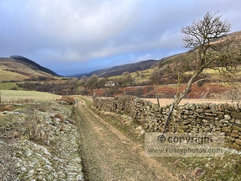 View across the Ashop river valley toward the ridge that leads up to Alport Castles on this 9‑mile Peak District walk