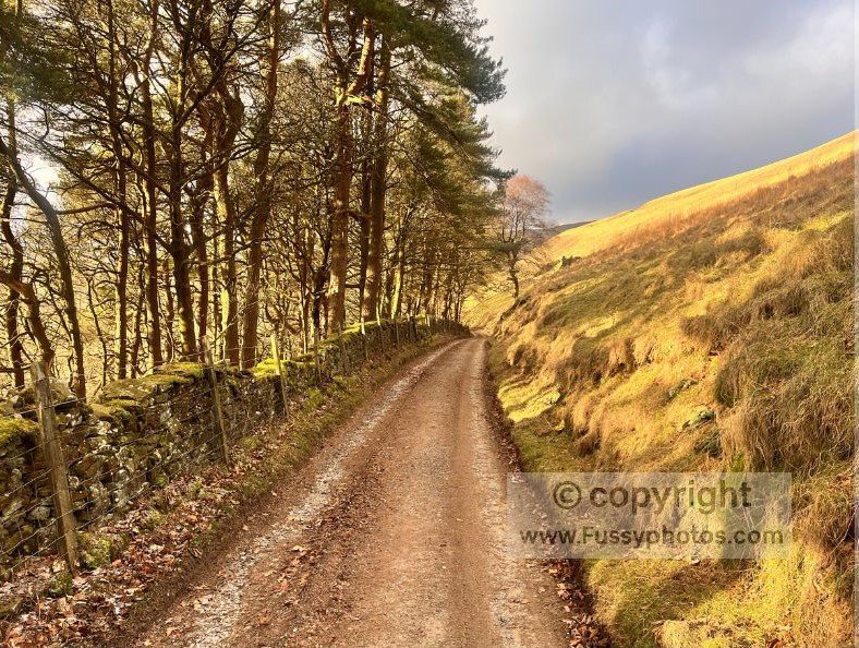 Walking towards steep tors and rugged scenery near Rowlee Farm