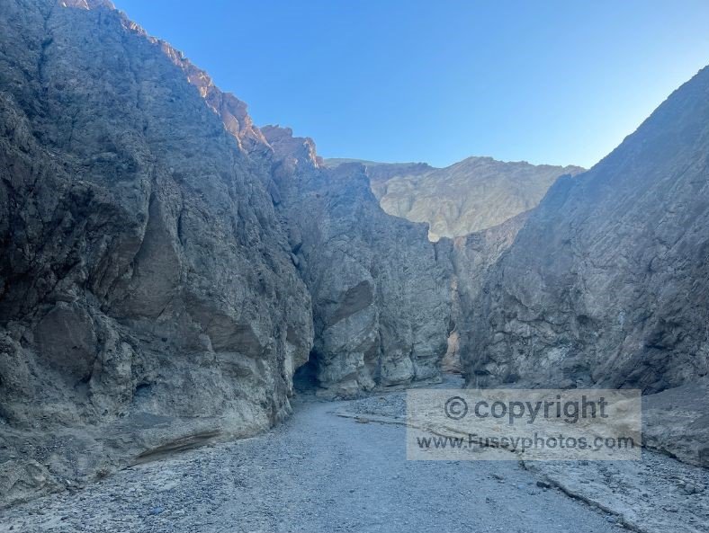 Golden Canyon after sunrise, starting the hike in deep shade beneath 30‑foot canyon walls — the coolest and most comfortable way to begin one of Death Valley’s best trails.