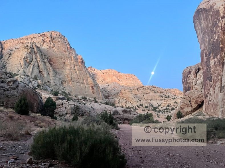Moonrise over the canyon walls in Grand Wash at dawn, captured on my 2‑day Capitol Reef backpacking loop.