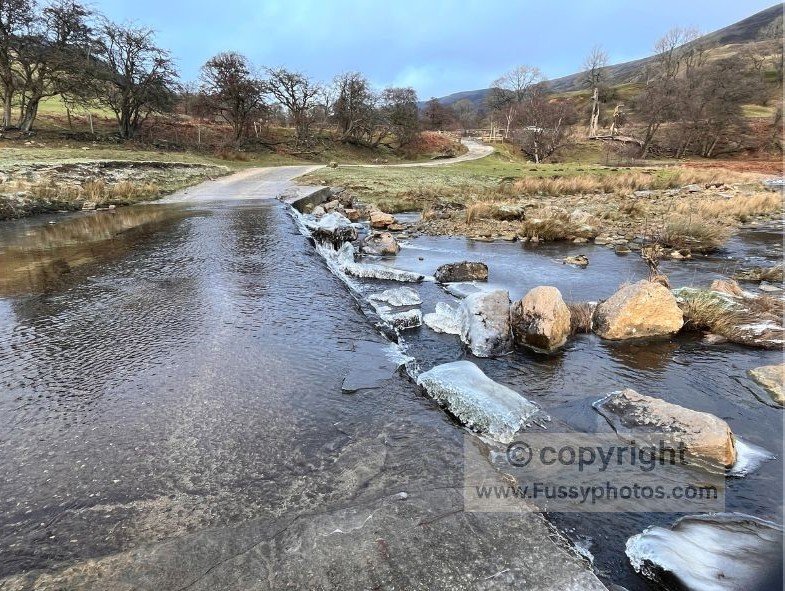 High‑flow River Ashop crossing on the approach toward Alport Castles in the Peak District