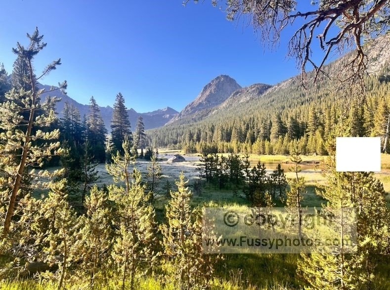 Frosty morning light over McClure Meadow on the John Muir Trail, with The Hermit’s twin triangular peaks rising above the flat, high‑elevation valley.