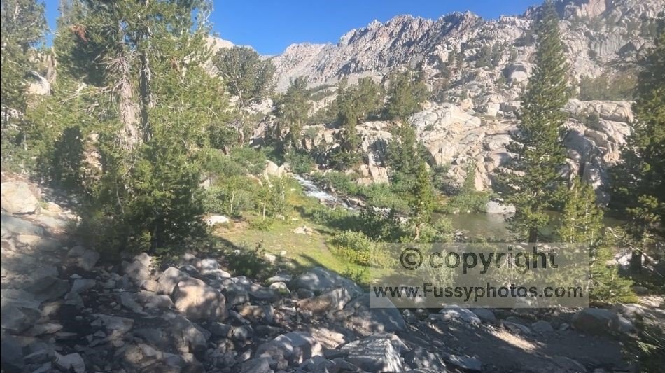 Waterfall along Lamarck Creek near the crossing point, with fast‑flowing water requiring careful footing.