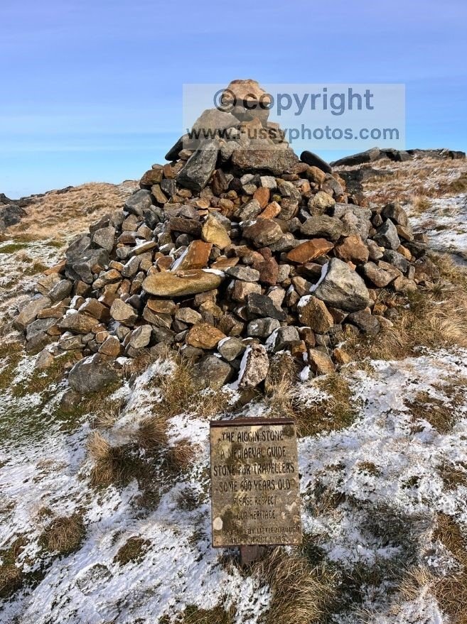 Aiggin Stone medieval guide stone on the Pennine Way in winter snow near Blackstone Edge