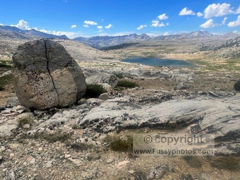 Glacial erratic beyond Piute Pass, with the plateau and Summit Lake stretching toward Piute Canyon.