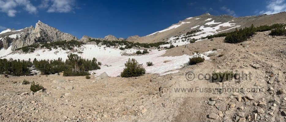 Steep, well‑graded trail climbing toward Kearsarge Pass with rugged granite peaks and alpine terrain surrounding the route.