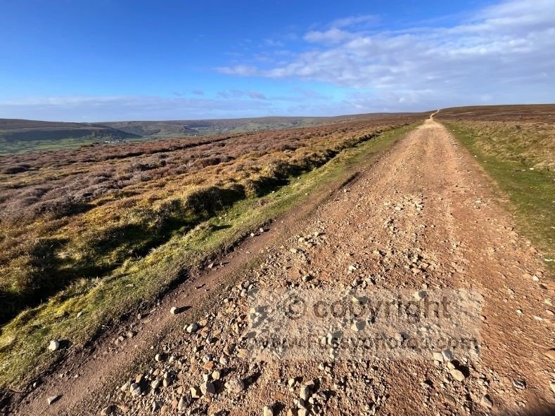 Bright, windy conditions on Glaisdale Moor along the Coast to Coast, showing open moorland and panoramic views in the sunshine.