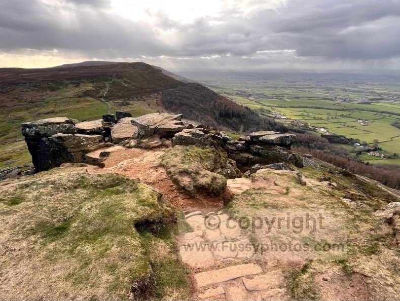 Westward view from above the Wainstones on the Coast to Coast, showing the distant Yorkshire Dales beyond the ridge.