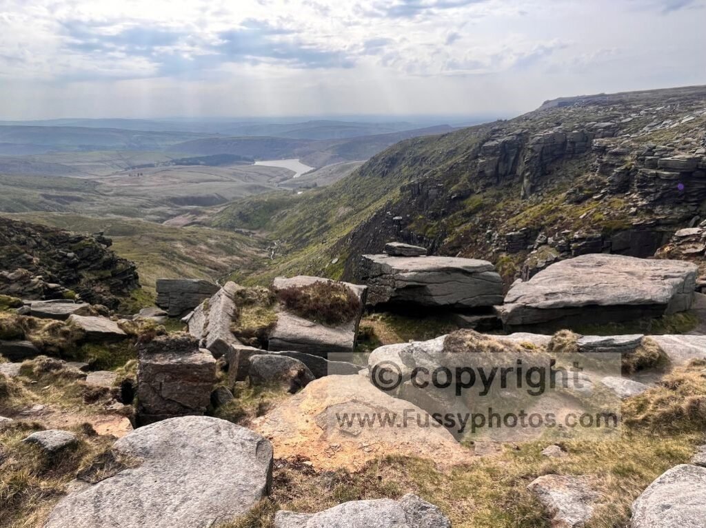 Looking down to Kinder Reservoir from the cliffs at Kinder Downfall on the Pennine Way.