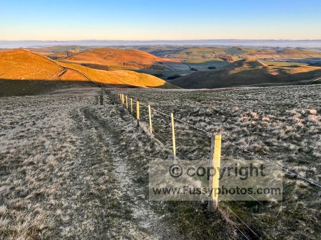 Sunrise across the Cheviot Hills, showing the isolated northern terrain of the Pennine Way.