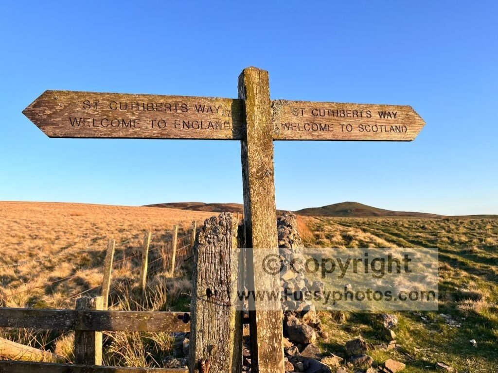 St Cuthbert’s Way sign on the England–Scotland border, reached after the steep final climb.