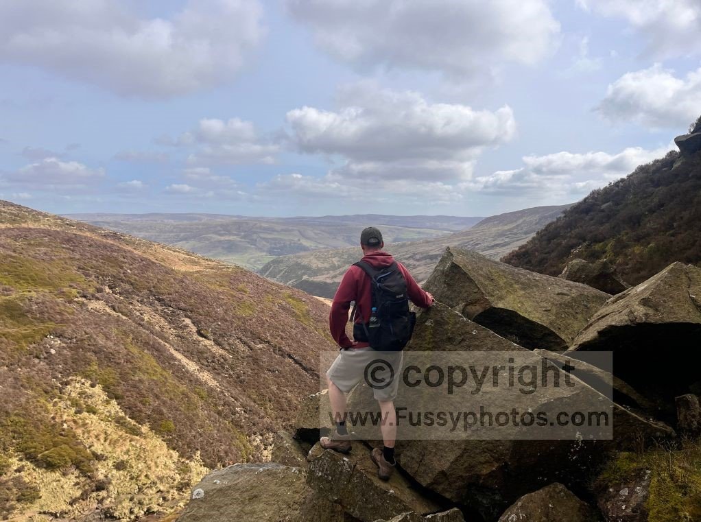 Hiker looking north from the scree scramble above Blackden Brook, facing the narrow valley climbed earlier.