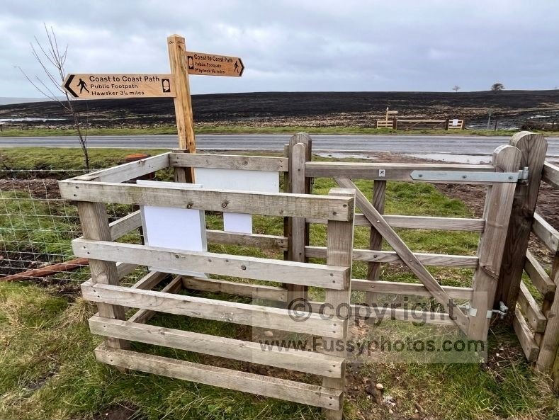 View of a Coast to Coast sign on Sneaton Low Moor, illustrating the clear waymarking across this open moorland section.