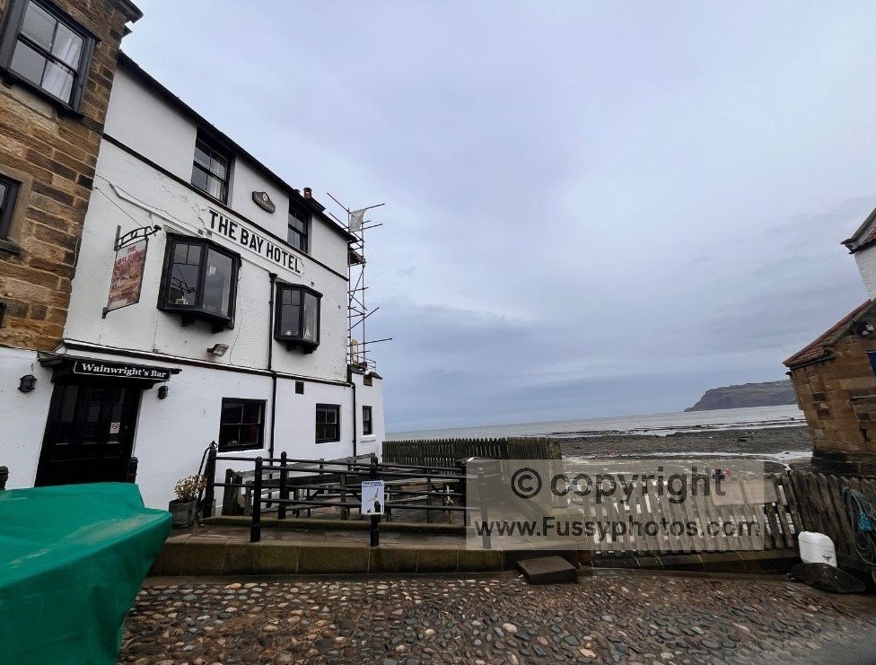 View of Wainwright’s Bar in Robin Hood’s Bay, looking out over the wave‑cut platform at the end of the Coast to Coast route.
