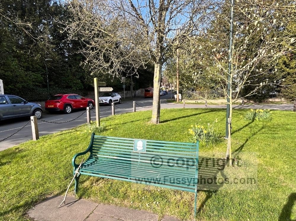 Bench in central Welton featuring the National Trails acorn symbol, with the Yorkshire Wolds Way visible behind on the approach to Welton Dale.