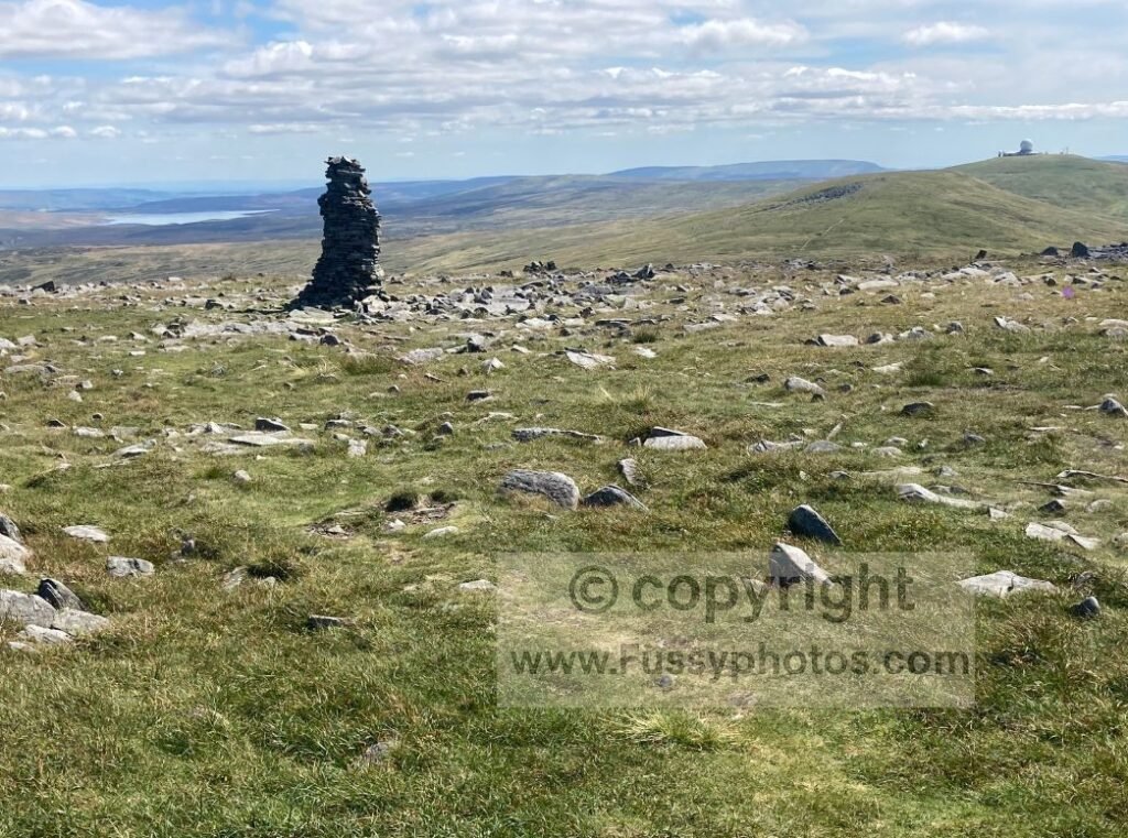 Southeast‑facing view on the ascent of Knock Fell, showing Great Dun Fell radar station and Cow Green Reservoir in the distance.