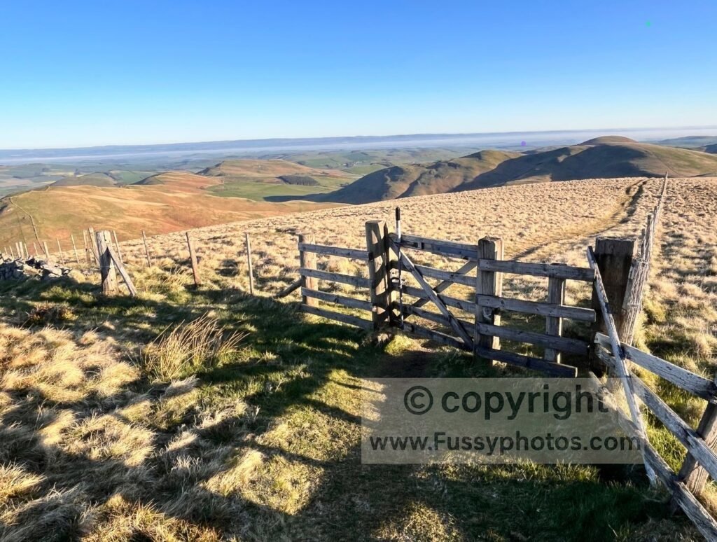 Northwest panorama from Whitelaw Nick, showing the open ridge and distant Cheviots in clear conditions.