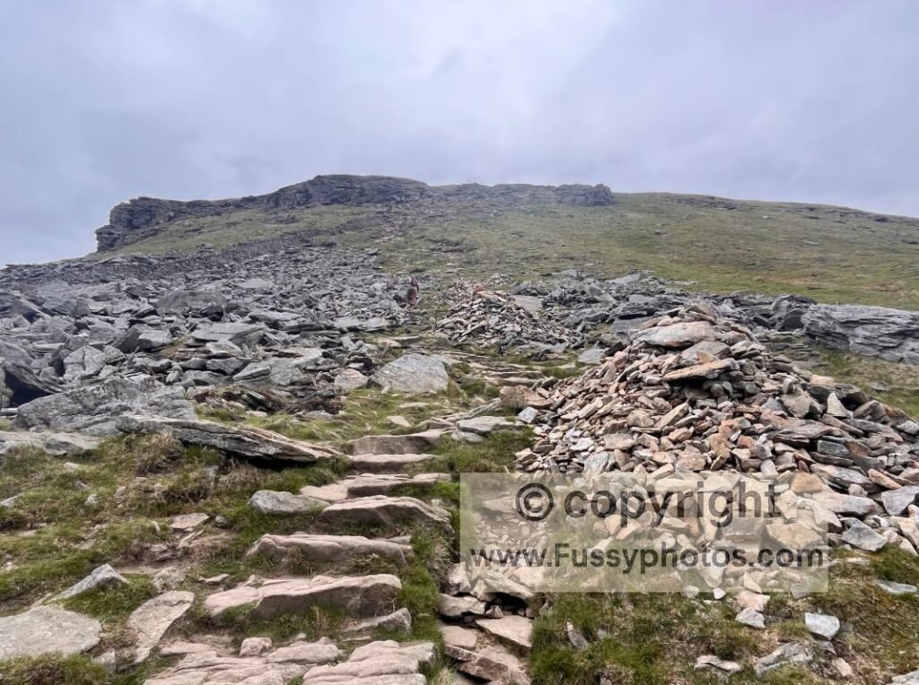 Steep southern ascent of Pen‑y‑Ghent, showing the exposed slope and rocky steps leading towards the summit.