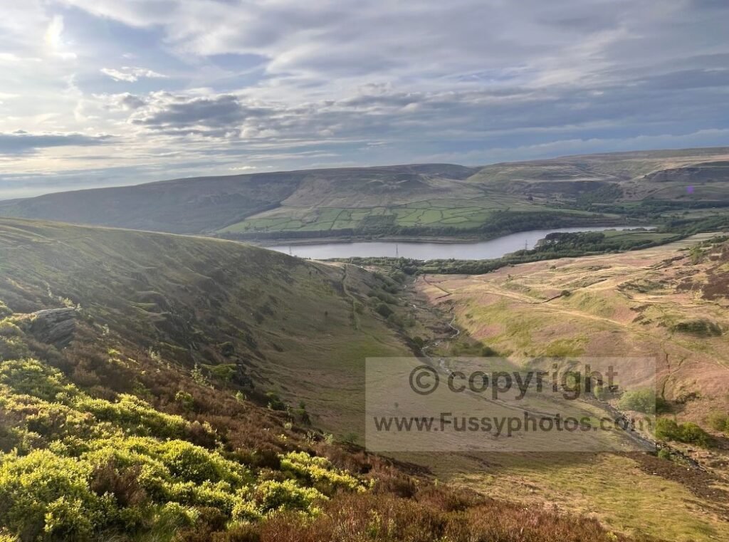 Clough Edge with descending left‑hand slope — Photo from Clough Edge showing the edge dropping away on the left where the best views appear, with Torside Reservoir just visible and Laddow Rocks in the distance.