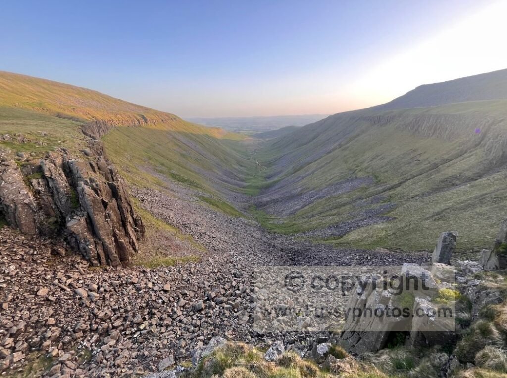 High Cup Nick shadowed alt — Photo of High Cup Nick mostly in shadow, seen after crossing the dry moor and reaching the valley rim from Dufton.