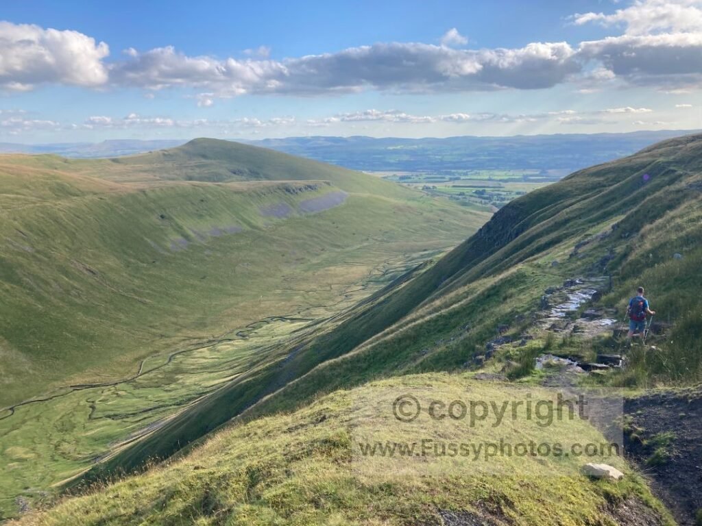 Walker on the northern edge of High Cup Nick, looking across the hanging valley.