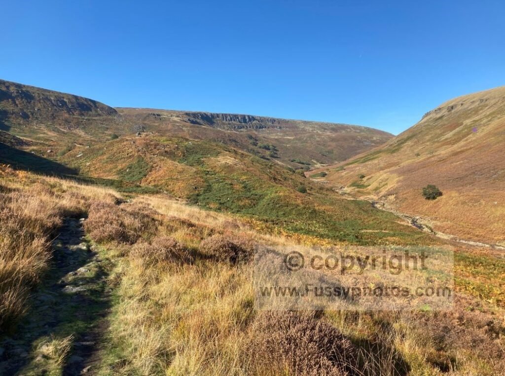 Walker ascending towards Laddow Rocks on Day 2 of the Pennine Way, with the valley narrowing and height building above Crowden.