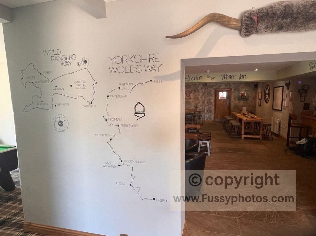 Wall‑painted map of the Yorkshire Wolds Way in the Manor Inn at Fridaythorpe, highlighting the village’s role as the midpoint and a practical staging point for walking the trail in sections.