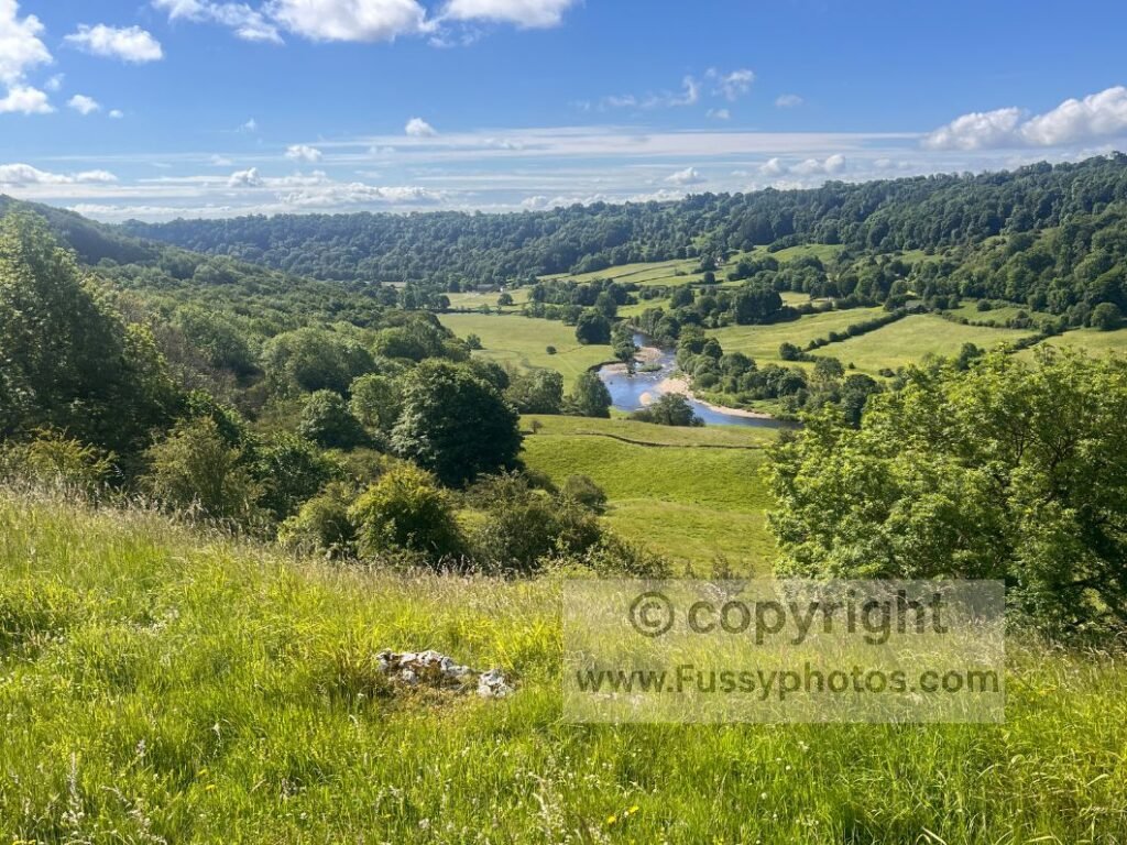 River Swale meander — elevated view on the Coast to Coast Path looking down to the River Swale winding through the valley.