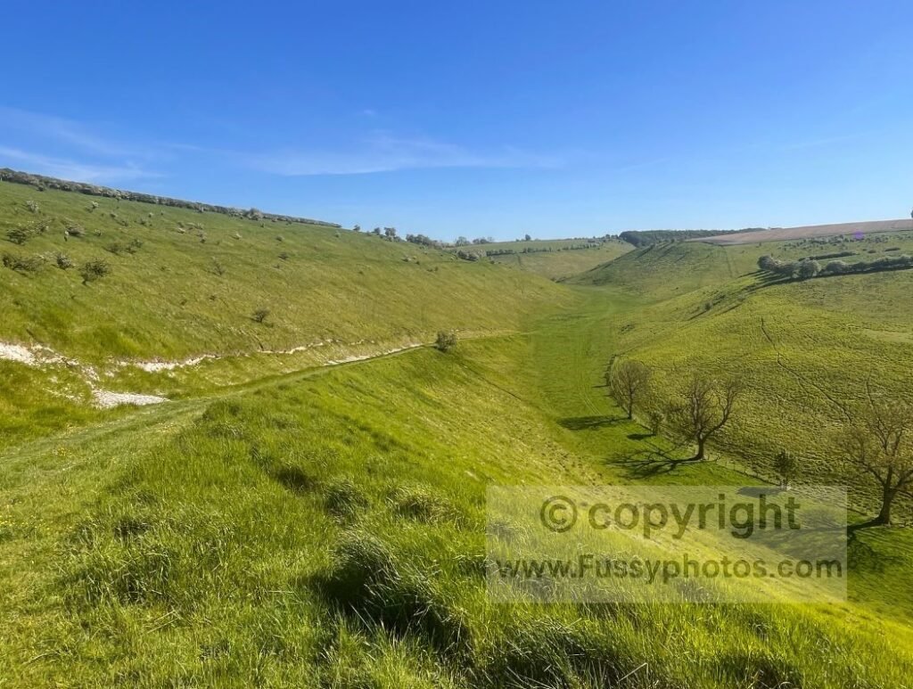 South‑west view into Thixen Dale from the Wolds Way, showing the sudden drop and the broad, curving valley where multiple dry valleys merge.