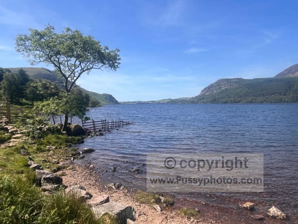 South‑eastern shore of Ennerdale Water, showing the rocky lakeside trail and a quiet spot used for a break before continuing beneath Crag Fell.