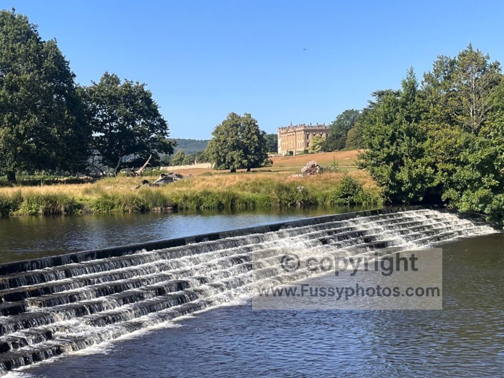 1840s River Derwent weir with Chatsworth House behind, a scenic but no‑swimming zone due to deep pools and strong undercurrents.