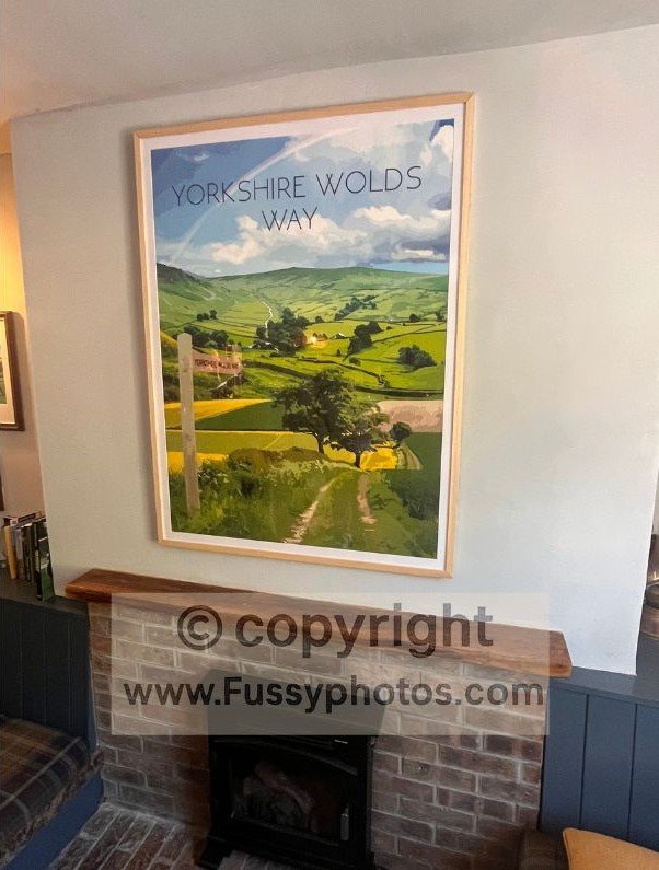 Framed Yorkshire Wolds Way poster on the wall of the Cross Keys Inn in Thixendale, showing an illustration that resembles the Yorkshire Dales more than the surrounding Wolds.
