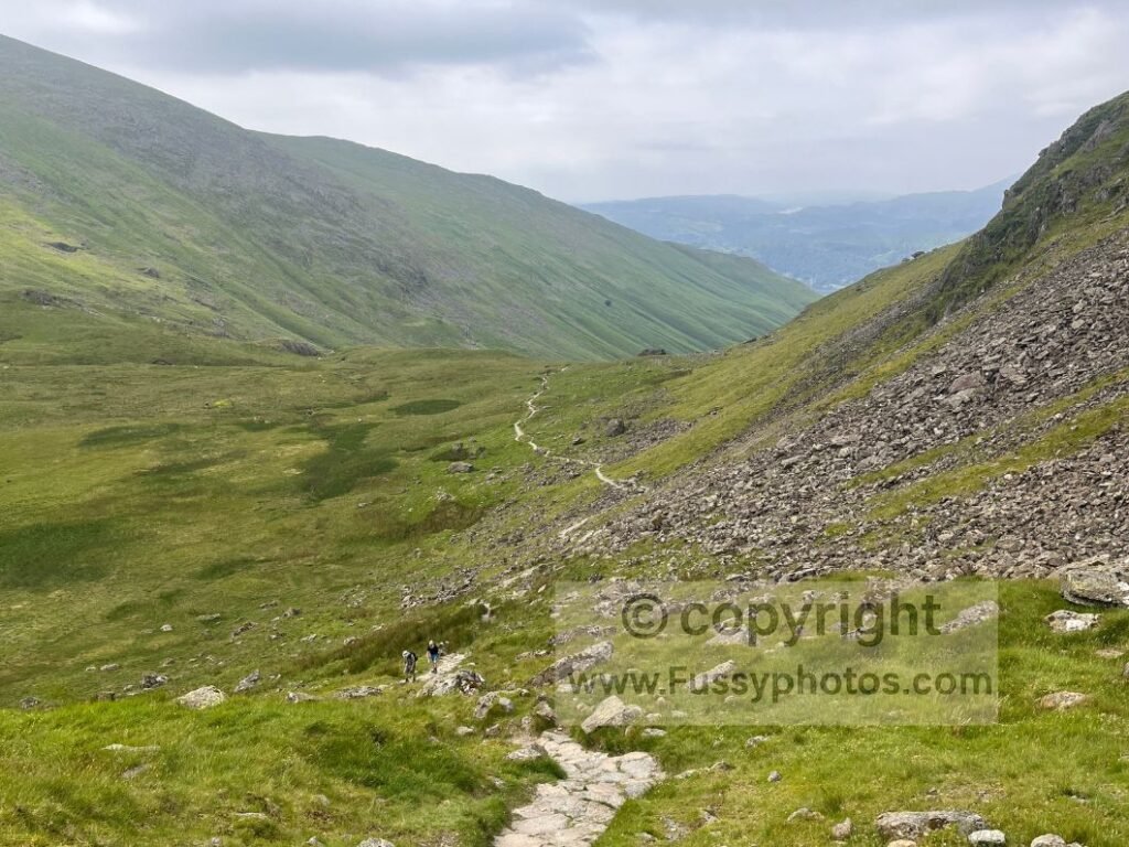 Rocky descent into Grasmere from Grisedale Tarn with wind and warm valley conditions.