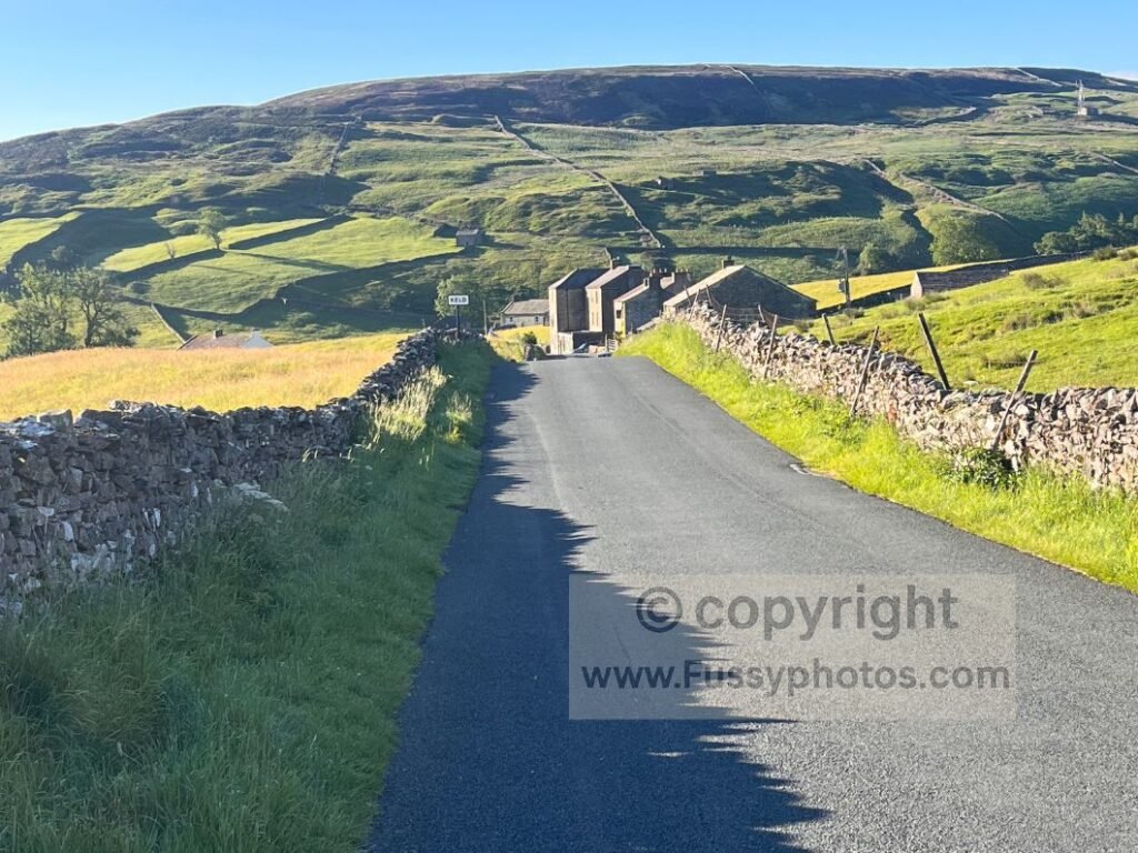 South‑facing photo of Keld from the Coast to Coast road section, showing the village in early‑morning light.