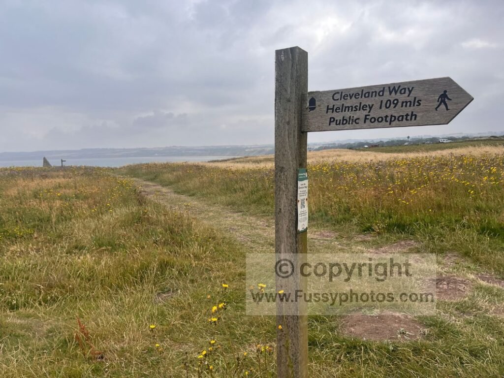 Trail sign at Filey Brigg showing the official start of the Cleveland Way, guiding walkers north along the coastline towards Scarborough.