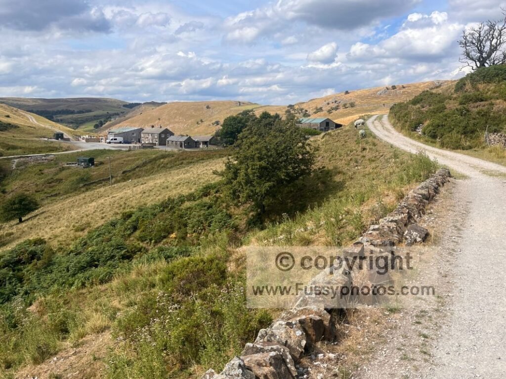 Gravel track approaching Booth Farm with wide limestone views between Fough and Booth Farm.