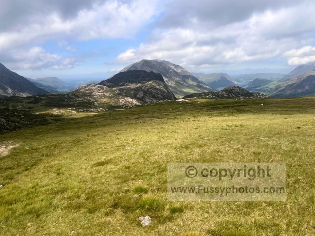 North‑west view of Ennerdale Valley (left) and the hanging valley toward Buttermere and Crummock Water (right), with Haystacks in the middle of the shot.