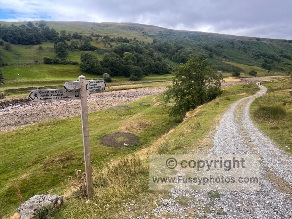 Finger sign on the low‑level Swaledale route near Keld by the River Swale.