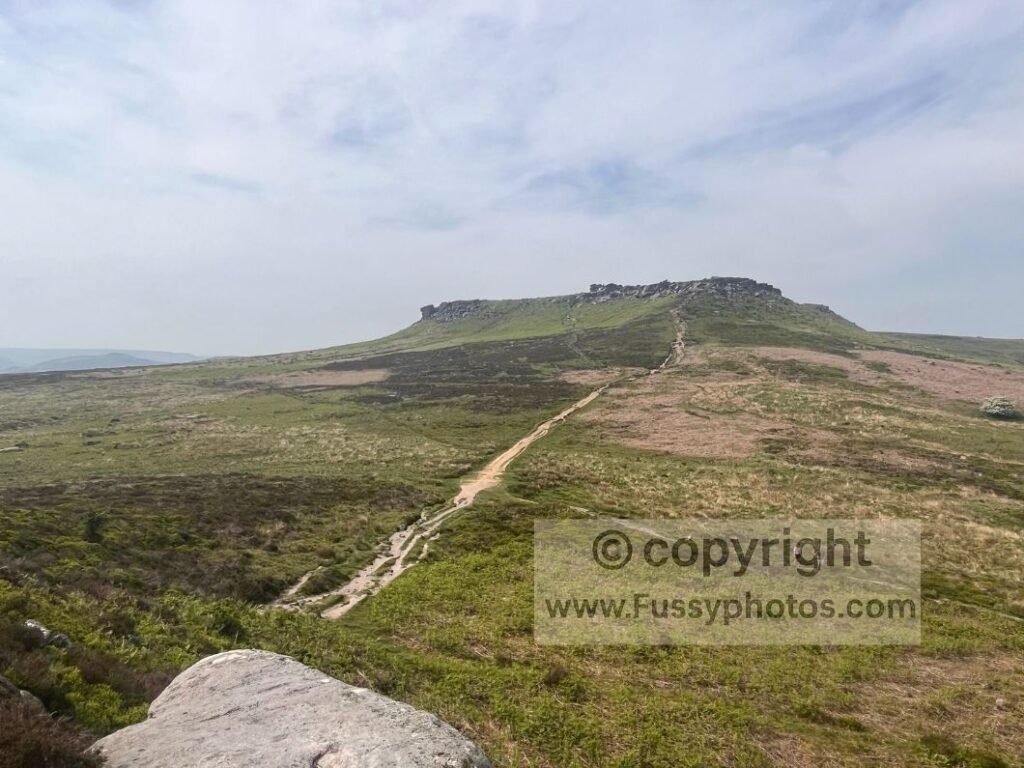 Northward view from Carl Wark, showing the path leading to Higger Tor across open moorland.