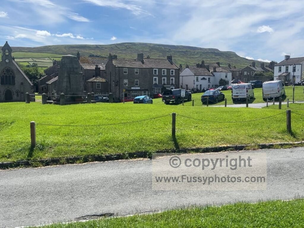 Bustling Reeth village centre with cafés and pubs, a key stop on the Coast to Coast four‑section itinerary.